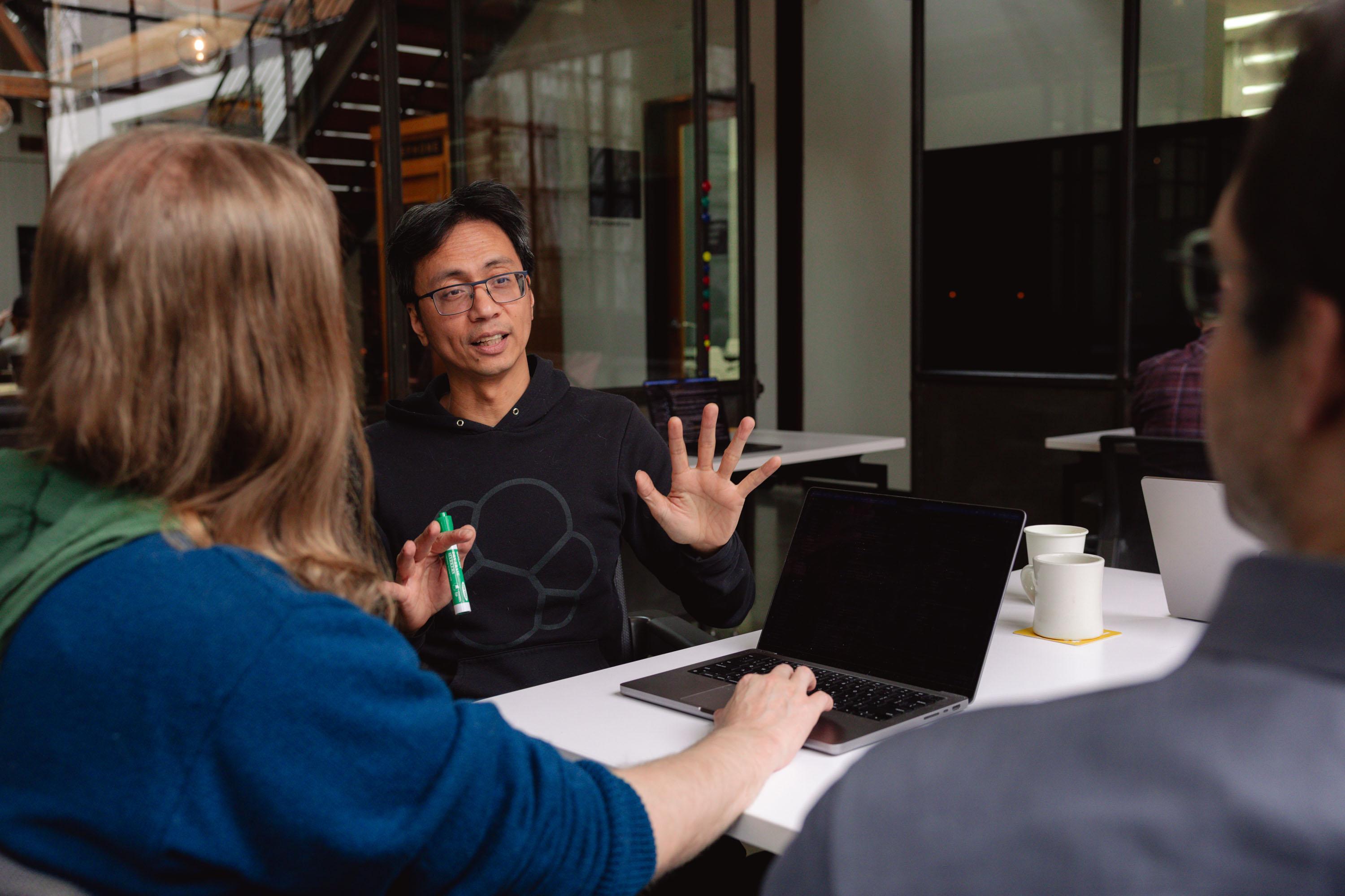 Olio Apps team members discussing technical solutions